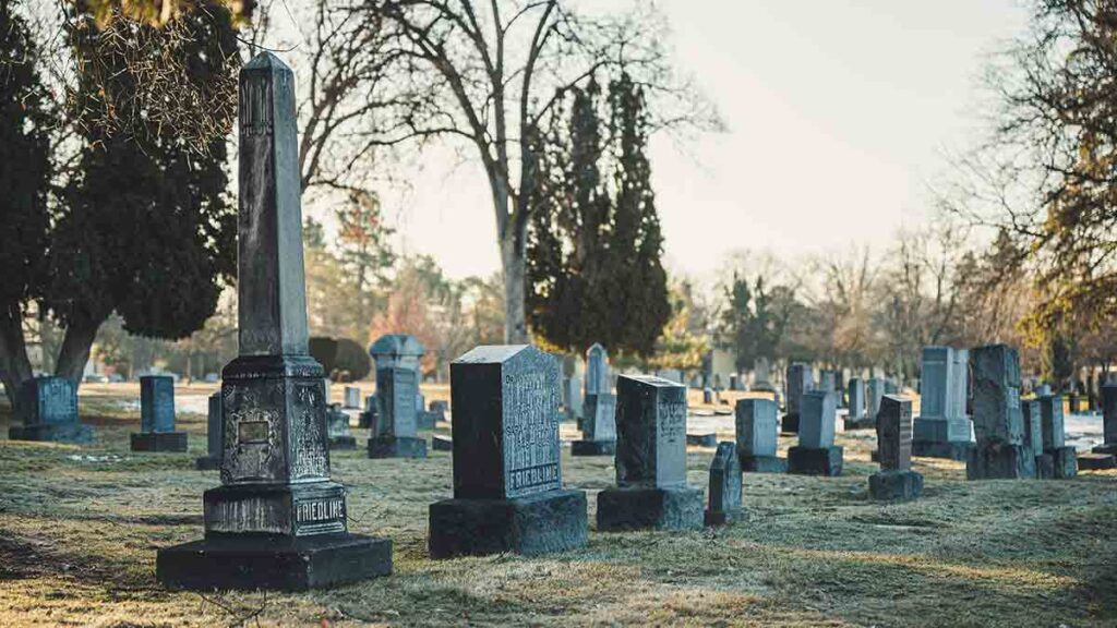 Several above ground tombstones in a cemetery