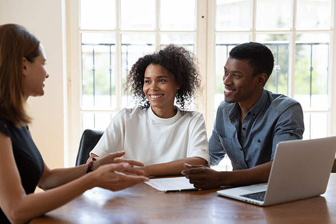 An interpreter helps a portfolio advisor explain a couple's investment options.