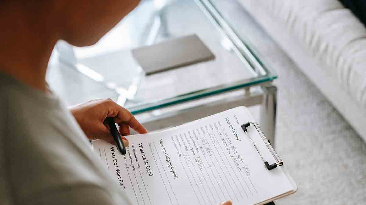 A healthcare provider looks through a medical questionnaire for a non-English-speaking patient.