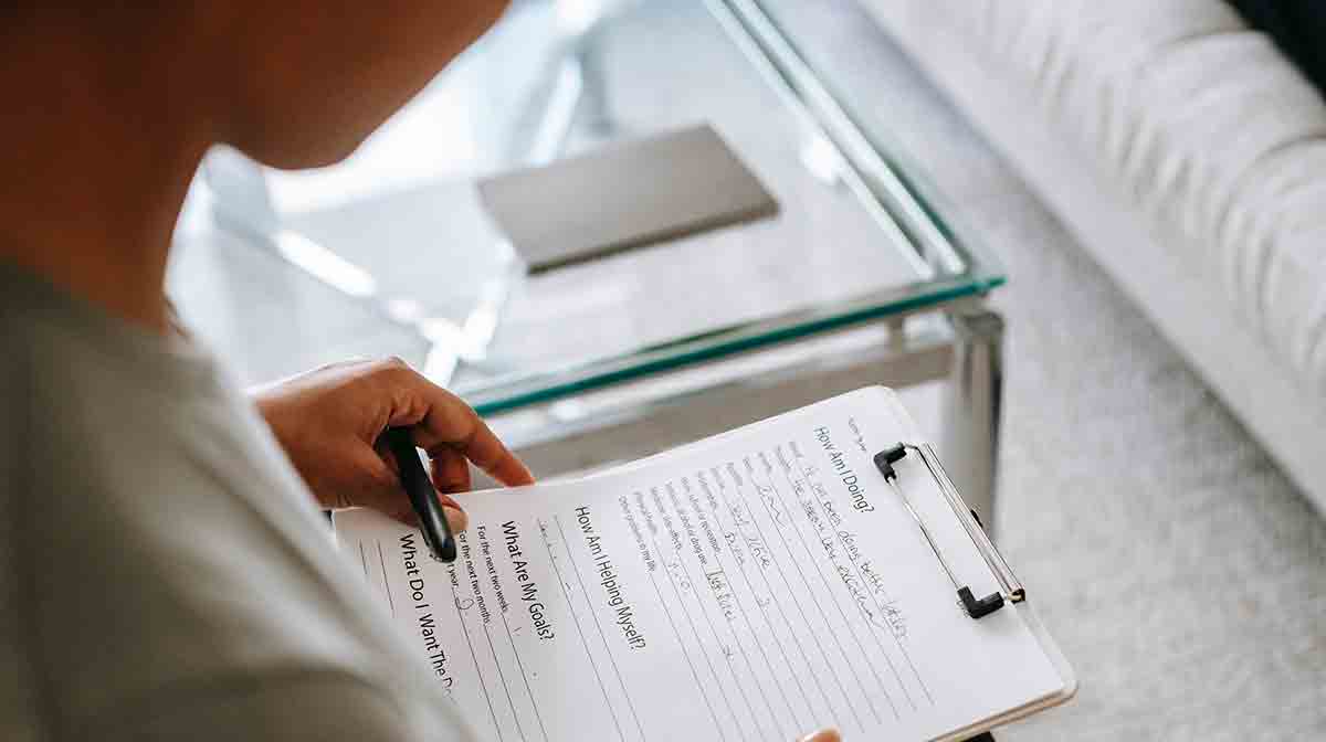 A healthcare provider looks through a medical questionnaire for a non-English-speaking patient.