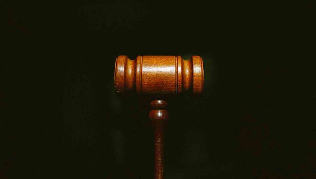 Close up of  brown gavel on a black background.