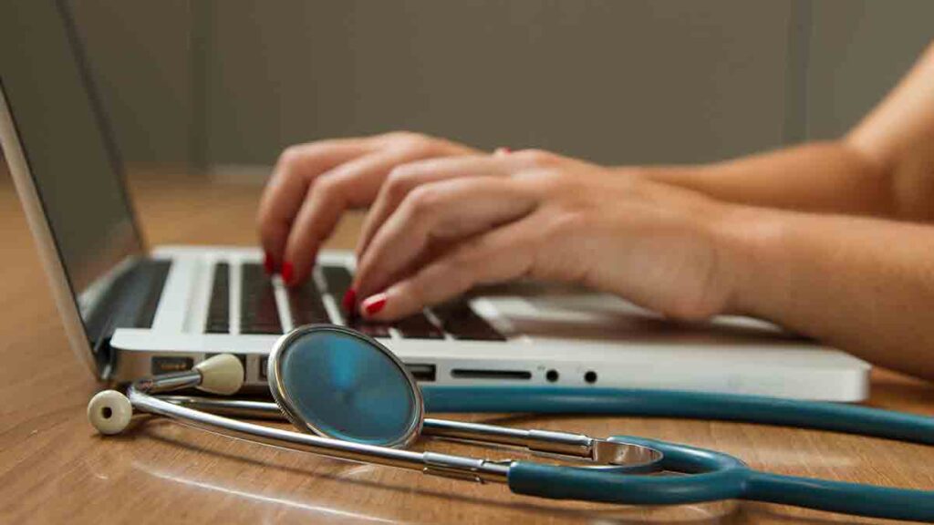 Female clinician using a laptop to initiate a telemedicine and interpreting session